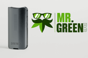 DaVinci IQ3 portable vaporizer in brushed metal finish alongside MrGreenDC cannabis dispensary logo on white background